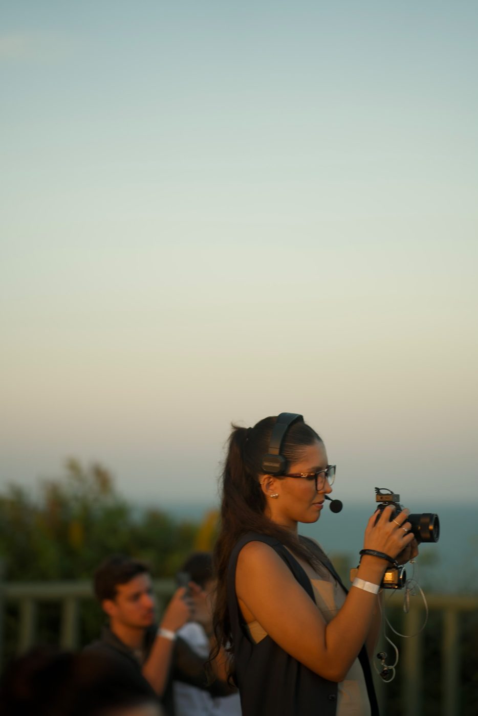 Gabriella gravando um evento ao pôr do sol
